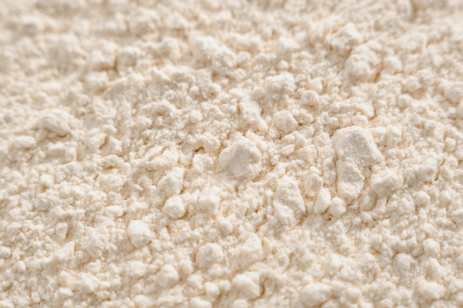 About Us Detailed close-up of a white powder texture, resembling flour or sugar.